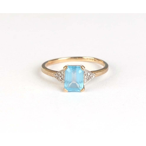 832 - A 9ct gold dress ring set with a rectangular pale blue stone, approx UK size R, 2.4g.