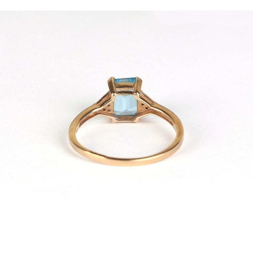 832 - A 9ct gold dress ring set with a rectangular pale blue stone, approx UK size R, 2.4g.