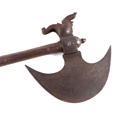 91 - An Indian axe with engraved crescent form axe head, 76cms long.