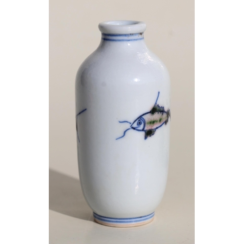 929 - A Chinese porcelain snuff bottle decorated with fish, on a hardwood stand, 7.5cms high.Condition Rep... 