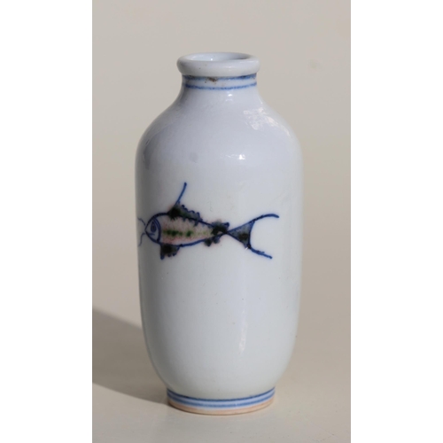 929 - A Chinese porcelain snuff bottle decorated with fish, on a hardwood stand, 7.5cms high.Condition Rep... 