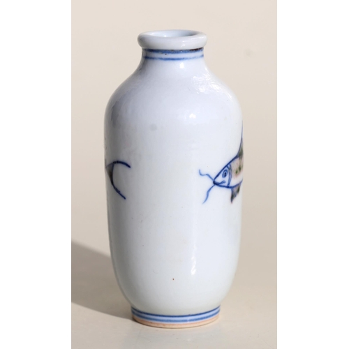 929 - A Chinese porcelain snuff bottle decorated with fish, on a hardwood stand, 7.5cms high.Condition Rep... 