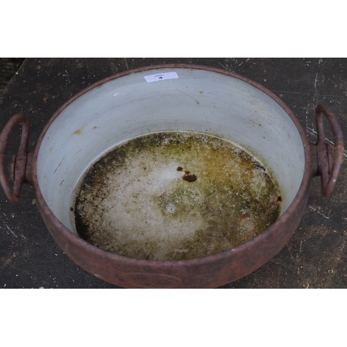 4 - A cast iron and enamel two-handled two-gallon cooking pot by Izons & Co., 34cms wide.