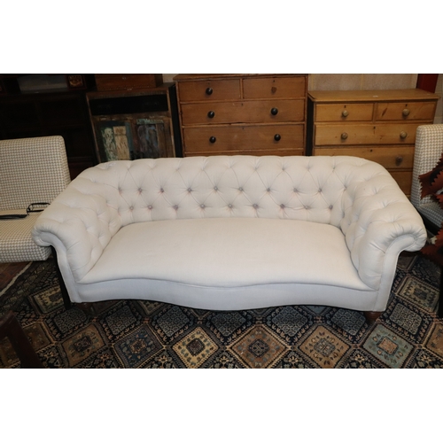 1043 - A Chesterfield cream upholstered three-seater  sofa on turned  front legs, approx 190cms wide.