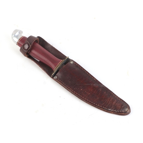 104 - A 1937 Boy Scout jamboree sheath knife and scabbard, the blade etched 'made in Finland' 19cm long