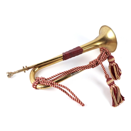 113 - A brass military bugle, 53cms long.