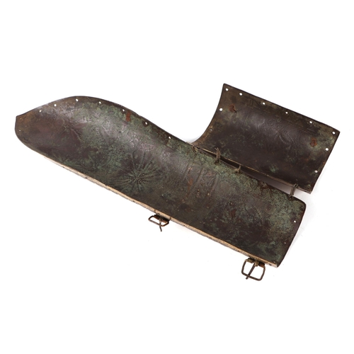 115 - A North Indian brass arm guard decorated with roundels and script, 34cms long.