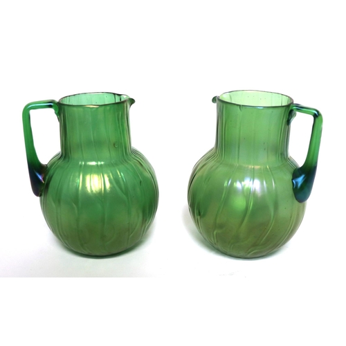 241 - A Loetz style Neptune pattern green iridescent glass jug of globe and shaft form with angular handle... 