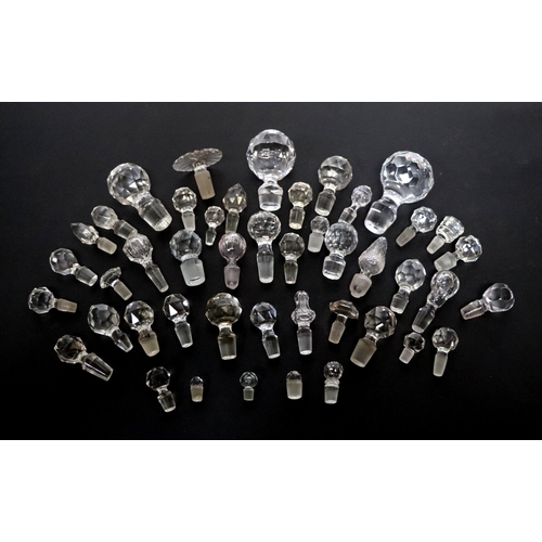 244 - A good selection of glass decanter stoppers to include faceted examples.