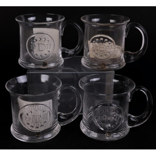 251 - A quantity of Dartington glass commemorative Christmas mugs.