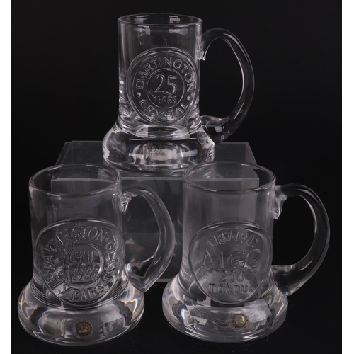 251 - A quantity of Dartington glass commemorative Christmas mugs.