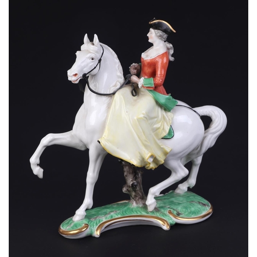 262 - A Nymphenburg porcelain group depicting a lady wearing a tricorn hat riding a horse sidesaddle, impr... 