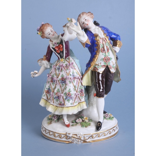 270 - A continental porcelain group depicting a dancing couple, 23cms high.Condition ReportThe young man's... 