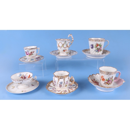 276 - A quantity of Dresden cups and saucers decorated with flowers.