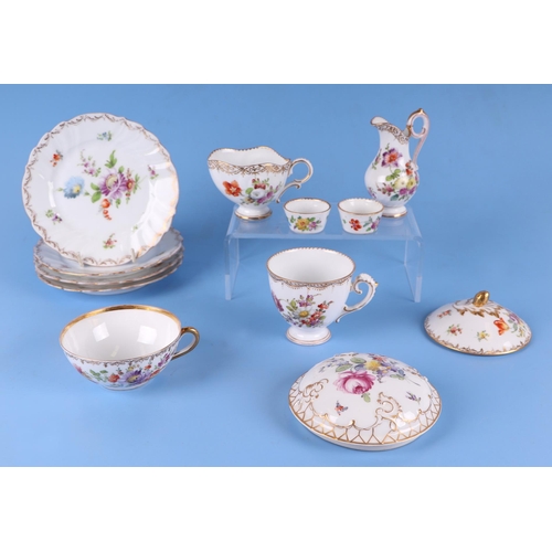 278 - A quantity of Dresden porcelain to include a desk stand, cream jug, plates and other items.