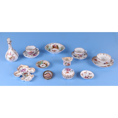 279 - A group of continental porcelain items to include a scent bottle, a top hat match striker, an oval p... 