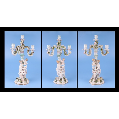 284 - Three continental porcelain figural three-armed candelabra with encrusted flower decoration, 52cms h... 