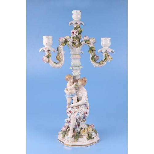 284 - Three continental porcelain figural three-armed candelabra with encrusted flower decoration, 52cms h... 