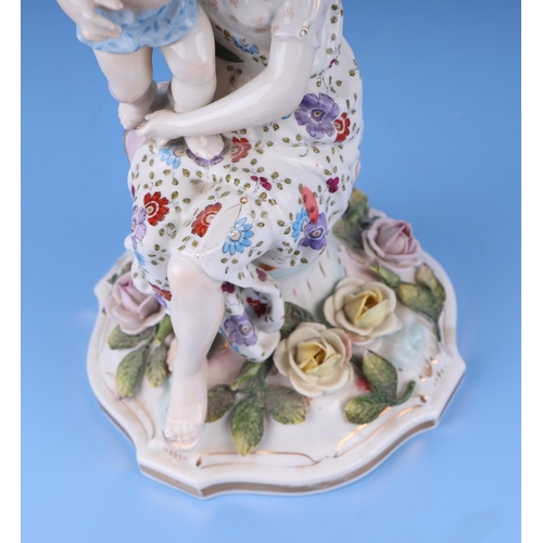 284 - Three continental porcelain figural three-armed candelabra with encrusted flower decoration, 52cms h... 