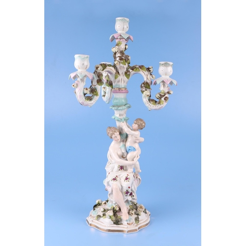 284 - Three continental porcelain figural three-armed candelabra with encrusted flower decoration, 52cms h... 