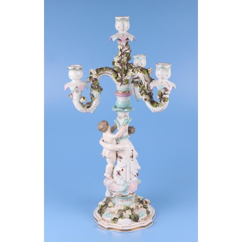 284 - Three continental porcelain figural three-armed candelabra with encrusted flower decoration, 52cms h... 