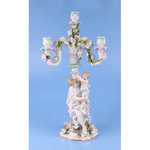 284 - Three continental porcelain figural three-armed candelabra with encrusted flower decoration, 52cms h... 