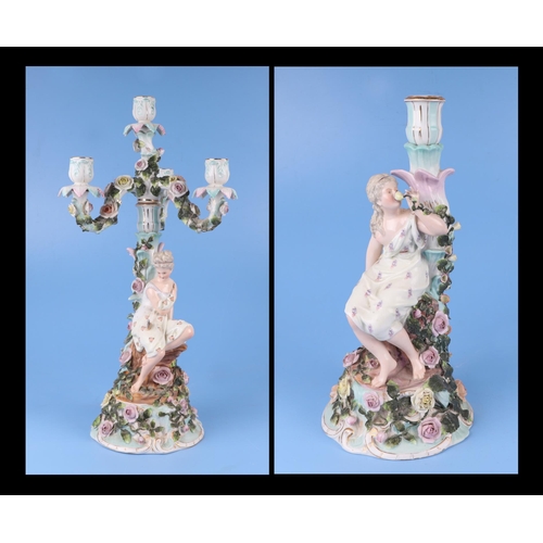 285 - A pair of continental porcelain figural candelabra with flower encrusted decoration (one lacking can... 