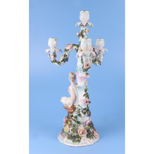 285 - A pair of continental porcelain figural candelabra with flower encrusted decoration (one lacking can... 