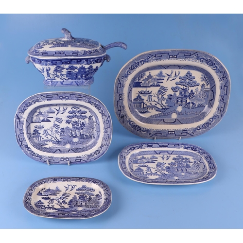 295 - A quantity of assorted Willow pattern and blue & white dinner wares to include a flow blue tureen & ... 