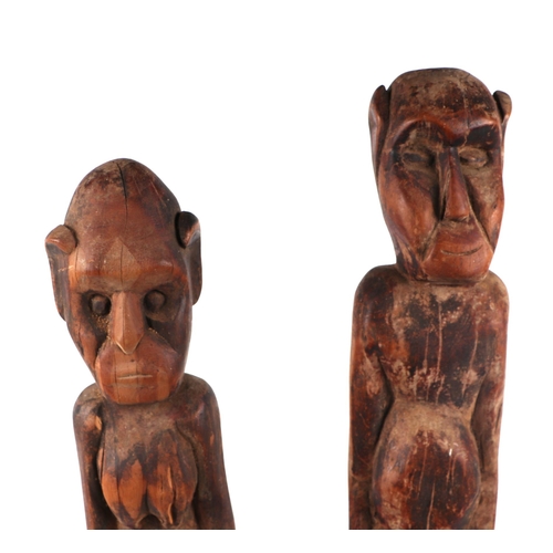 319 - A pair of African carved hardwood male and female fertility figures, each approx 72cms high (2).