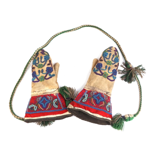 322 - A pair of late 19th / early 20th century Native American gloves with beadwork decoration.