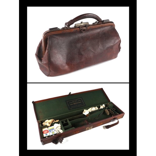 334 - An early 20th century Army & Navy leather trimmed canvas gun case; together with a leather Gladstone... 