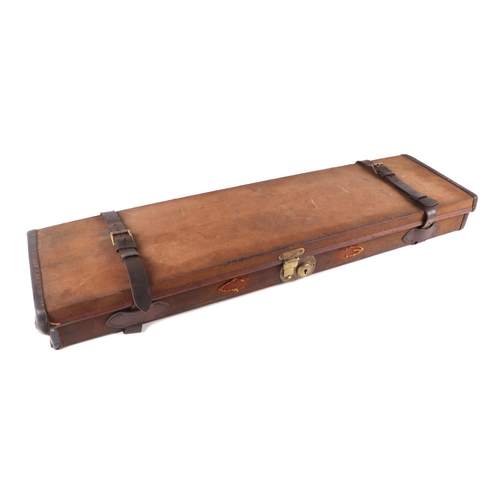 334 - An early 20th century Army & Navy leather trimmed canvas gun case; together with a leather Gladstone... 