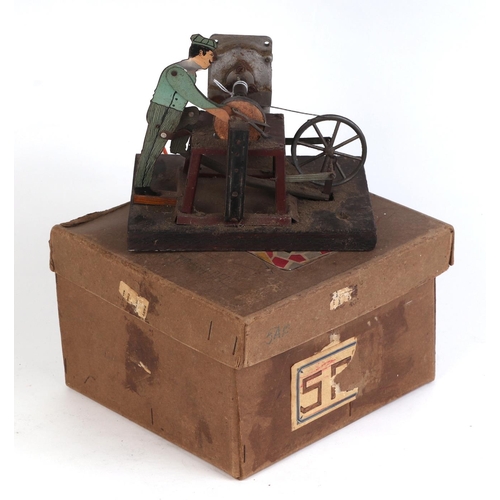 337 - A German Fleischmann tin scissor grinder.