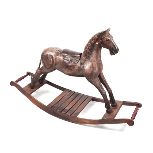 339 - An antique style carved wooden rocking horse, overall 125cm long.