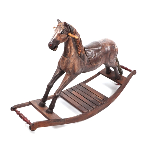 339 - An antique style carved wooden rocking horse, overall 125cm long.