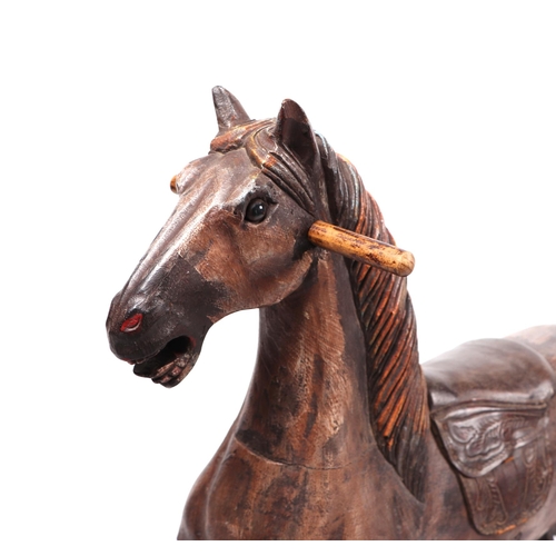 339 - An antique style carved wooden rocking horse, overall 125cm long.