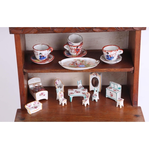 344 - An oak  doll's house dresser, 23cms wide; together with a group of doll's house ceramics, mostly Lim... 