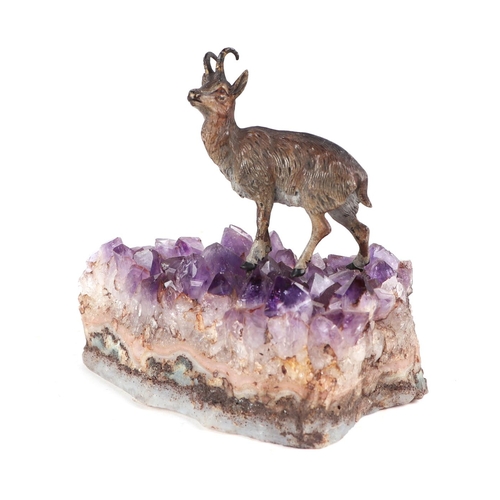 362 - A cold painted bronze Chamois mounted on an amethyst crystal base, 12cms wide.