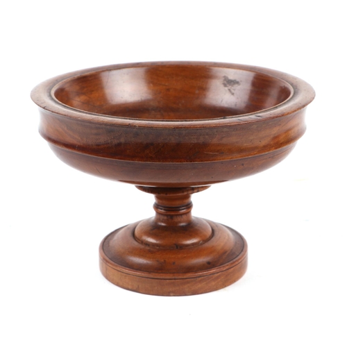 379 - A 19th century turned walnut bowl with three painted wooden fruit, 16cms diameter.