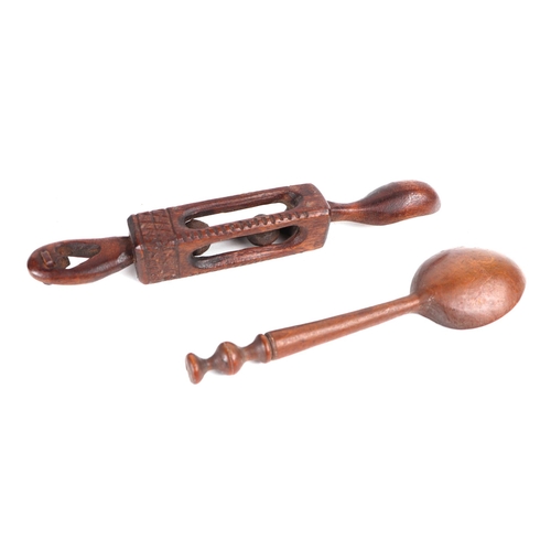 383 - A Welsh carved wooden love spoon, 20cms long; together with another carved wooden spoon with seal fi... 