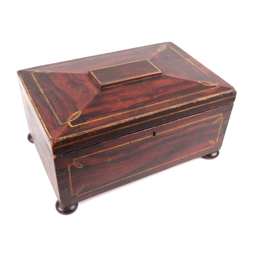 385 - A 19th century faux rosewood workbox of sarcophagus form, on bun feet, 31.5cms wide.