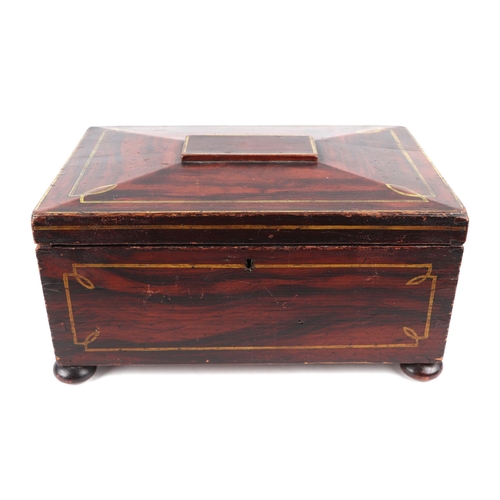 385 - A 19th century faux rosewood workbox of sarcophagus form, on bun feet, 31.5cms wide.