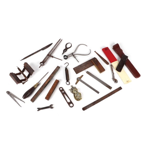 410 - A quantity of leather cased and similar measures; together with woodworking tools; scales and other ... 