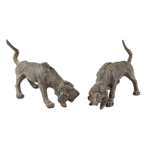 414 - A pair of patenated iron bloodhounds, 24cms long; together with a pair of patinated lurchers, 36cms ... 