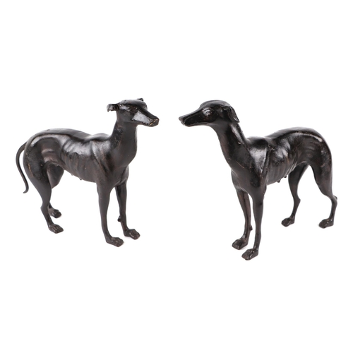 414 - A pair of patenated iron bloodhounds, 24cms long; together with a pair of patinated lurchers, 36cms ... 