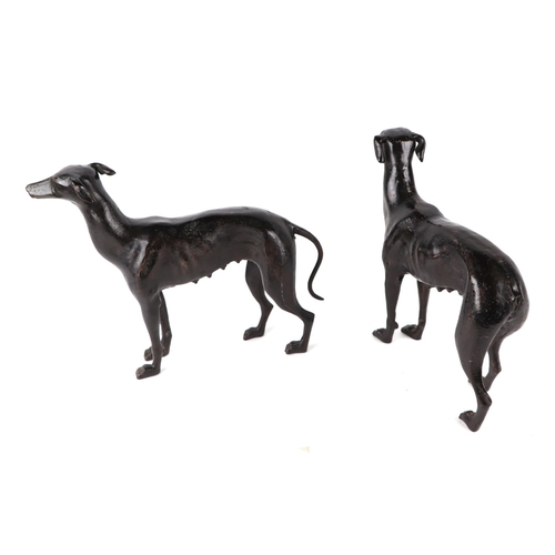 414 - A pair of patenated iron bloodhounds, 24cms long; together with a pair of patinated lurchers, 36cms ... 