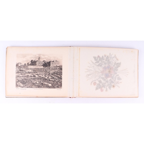 418 - An early 20th century olive wood souvenir booklet of Palestine featuring photographs and pressed flo... 