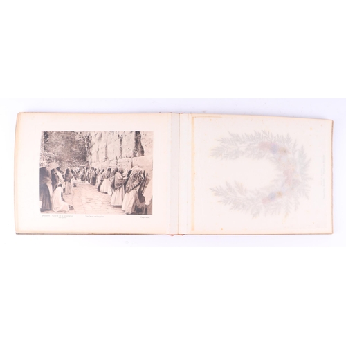 418 - An early 20th century olive wood souvenir booklet of Palestine featuring photographs and pressed flo... 