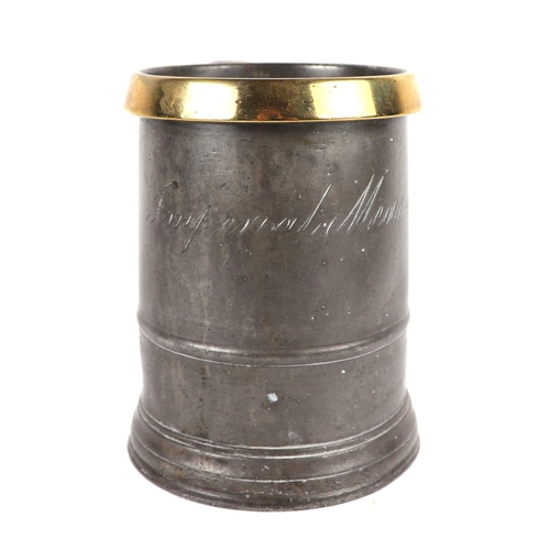 420 - A Victorian quart pewter tankard with copper rim, 'C' scroll handle and inscription; together with a... 